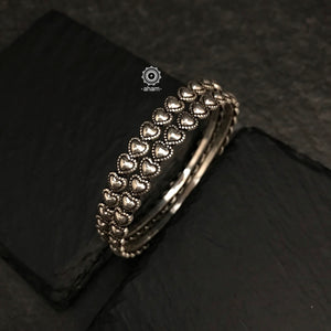 Handcrafted everyday wear bangles in 92.5 sterling silver with intricate heart shaped design.