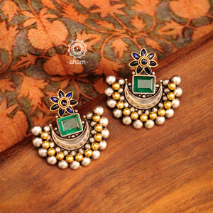 Noori two tone crescent earrings with semi precious green stone. Handcrafted in 92.5 sterling silver with blue spinel flower motif. Subtle elegance that add charm to your look. 
