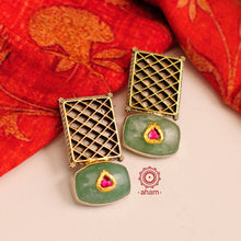 Noori two tone earrings with green semi precious stone setting. Handcrafted in 92.5 sterling silver. Style this up with your favourite ethnic or fusion outfits to complete the look.