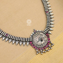 Make a sophisticated style statement this festive season in this nrityam peacock neckpiece. The necklace is crafted in 92.5 sterling silver using traditional artistry with intricate Goddess Lakshmi motif and maroon kemp stones. Perfect for intimate weddings and upcoming festive celebrations.
